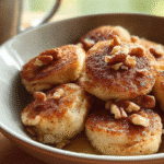 Banana Nut Cottage Cheese Pancake Bites – Fluffy, Sweet & Protein-Packed 6 Close-up of Banana Nut Cottage Cheese Pancake Bites on a wooden table, bathed in natural daylight with a cozy, homey kitchen background.