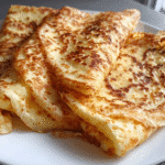 stack of cottage cheese crepes topped with berries