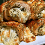 pesto chicken rolls sliced on plate