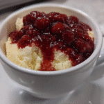 Vanilla bean cottage cheese mug cake topped with berry compote