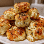 golden garlic bites on parchment paper