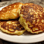 cottage pancakes served with fresh fruit and a side of Greek yogurt